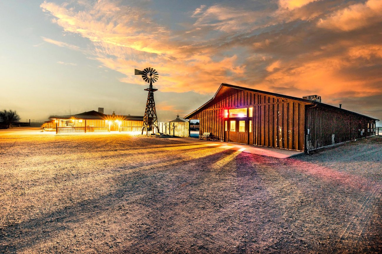 property-with-lodge-and-windmill-at-sunset-colorado-bow-barrel-lodge